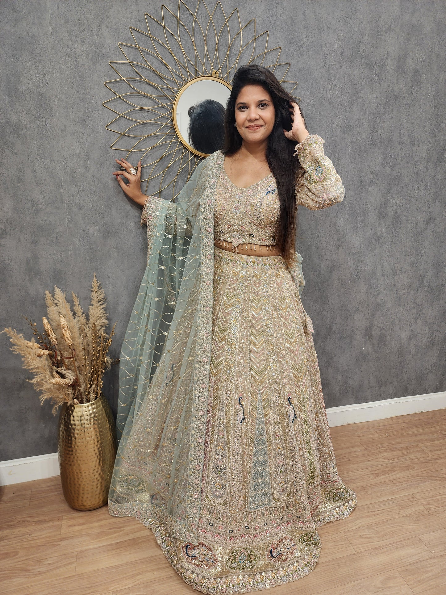 Peacock aariwork net lehenga with sky dupatta