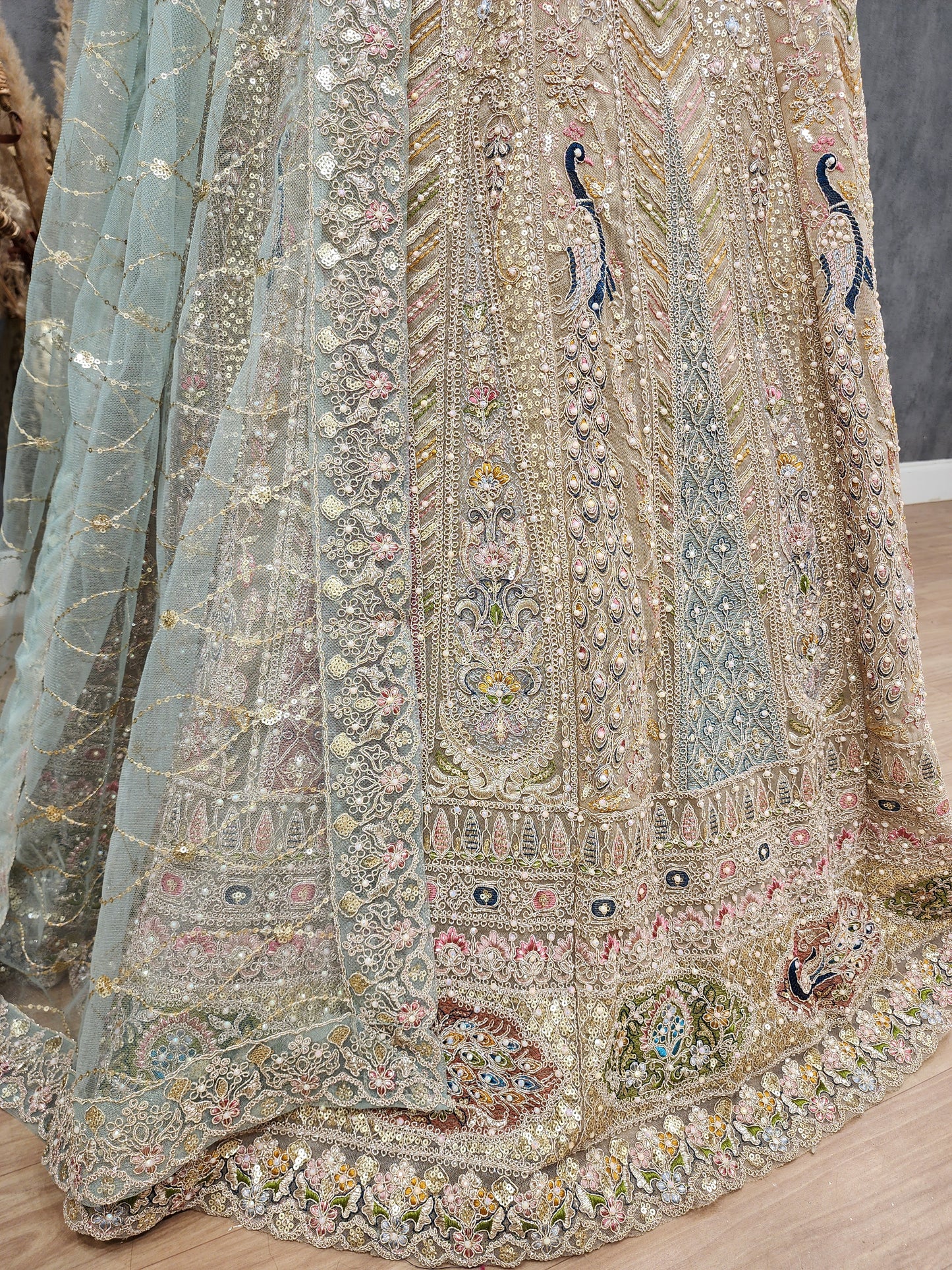 Peacock aariwork net lehenga with sky dupatta