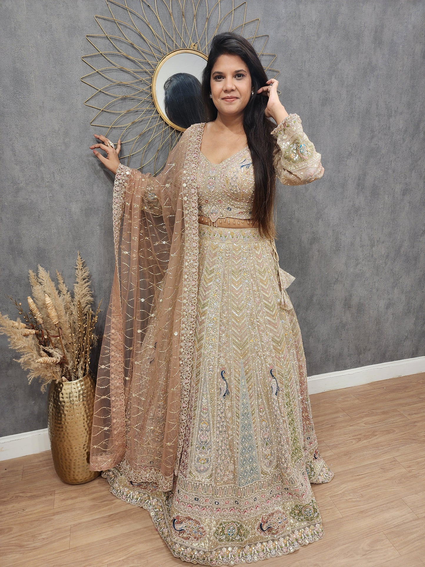 Peacock aariwork net lehenga with peach dupatta