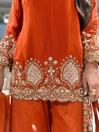 Rust orange crepe embellished sharara suit with purse