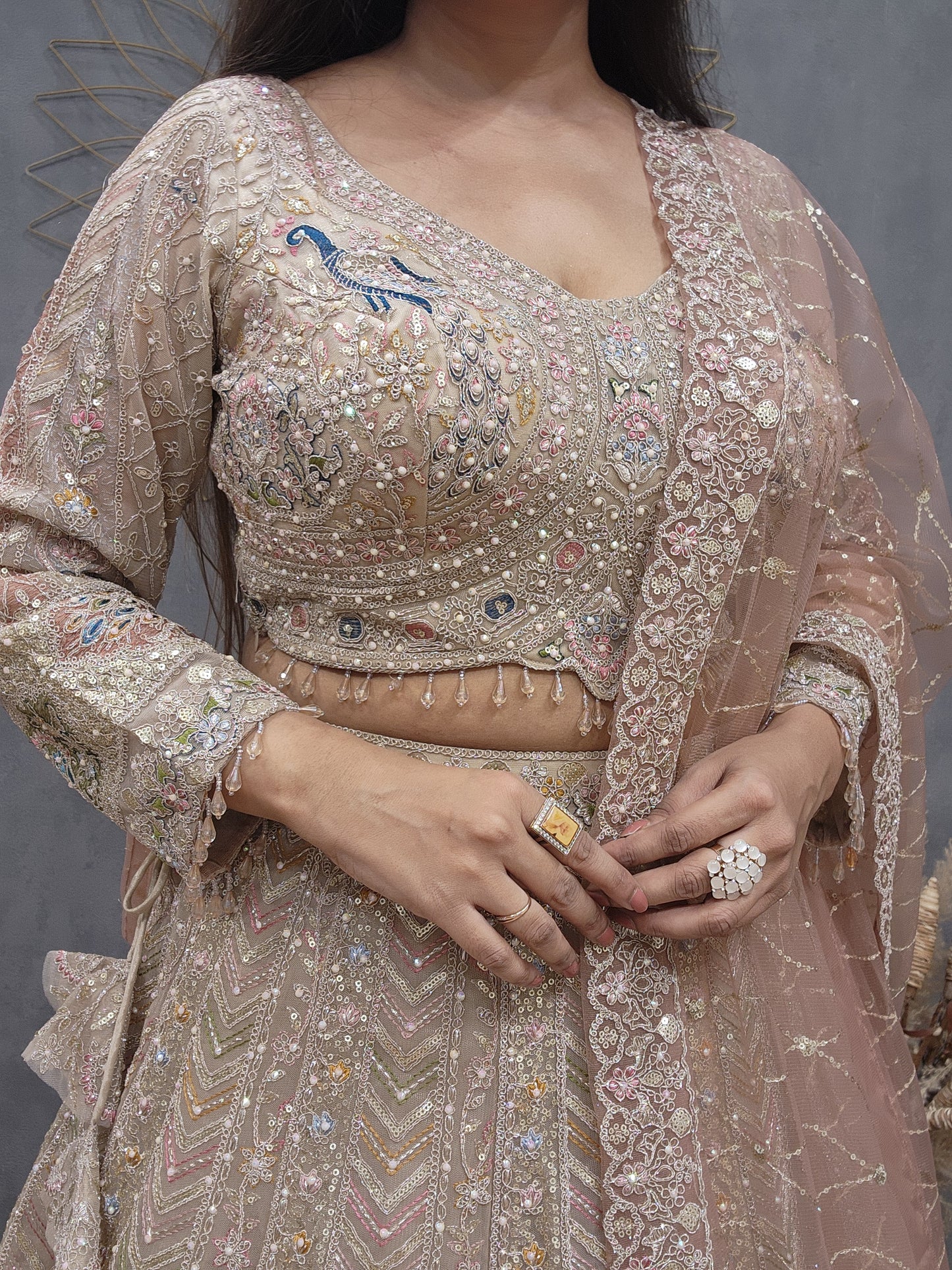 Peacock aariwork net lehenga with peach dupatta