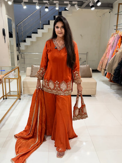 Rust orange crepe embellished sharara suit with purse